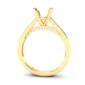 Yellow gold engagement ring setting with a four-prong mount for a central gemstone. Beneath the mount, a curved bridge features a row of small round diamonds. The polished band has a sleek, modern profile.