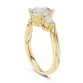 Three stone engagement ring in yellow gold with round side diamonds and elegant curved band